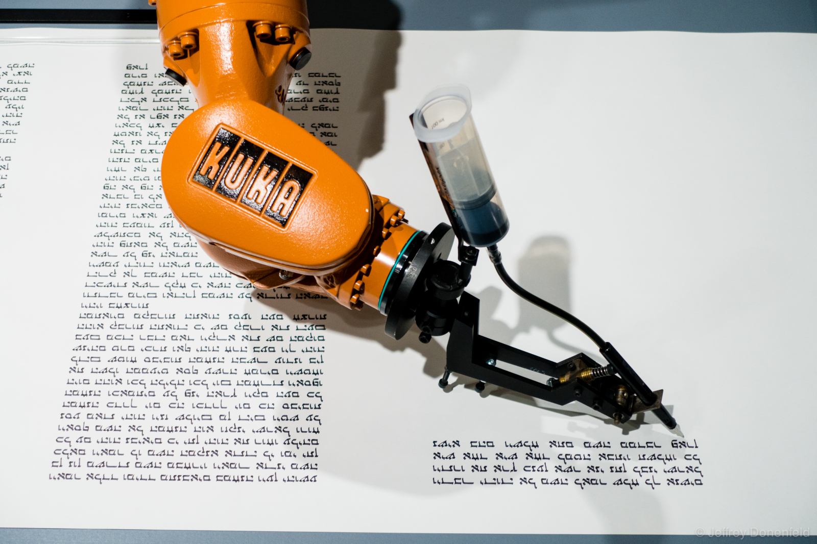 A robot writing a Torah at the Jewish Museum, Berlin