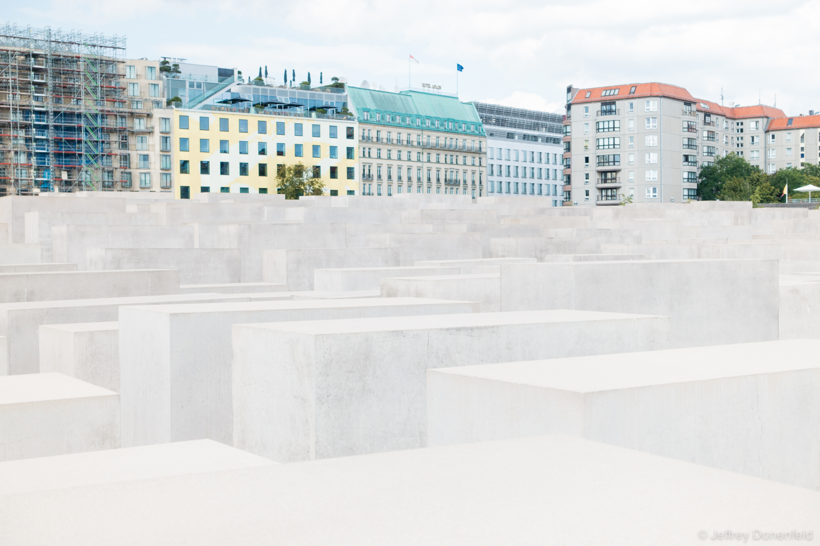 Berlin Memorial to the Murdered Jews of Europe. From Wikipedia: "The Memorial to the Murdered Jews of Europe[1] (German: Denkmal für die ermordeten Juden Europas), also known as the Holocaust Memorial (German: Holocaust-Mahnmal), is a memorial in Berlin to the Jewish victims of the Holocaust, designed by architect Peter Eisenman and engineer Buro Happold. It consists of a 19,000 m2 (4.7-acre) site covered with 2,711 concrete slabs or "stelae", arranged in a grid pattern on a sloping field. The stelae are 2.38 m (7 ft 10 in) long, 0.95 m (3 ft 1 in) wide and vary in height from 0.2 to 4.8 m (7.9 in to 15 ft 9.0 in). According to Eisenman's project text, the stelae are designed to produce an uneasy, confusing atmosphere, and the whole sculpture aims to represent a supposedly ordered system that has lost touch with human reason. A 2005 copy of the Foundation for the Memorial's official English tourist pamphlet, however, states that the design represents a radical approach to the traditional concept of a memorial, partly because Eisenman did not use any symbolism. However, observers have noted the memorial's resemblance to a cemetery.[2][3][4] An attached underground "Place of Information" (German: Ort der Information) holds the names of all known Jewish Holocaust victims, obtained from the Israeli museum Yad Vashem. 