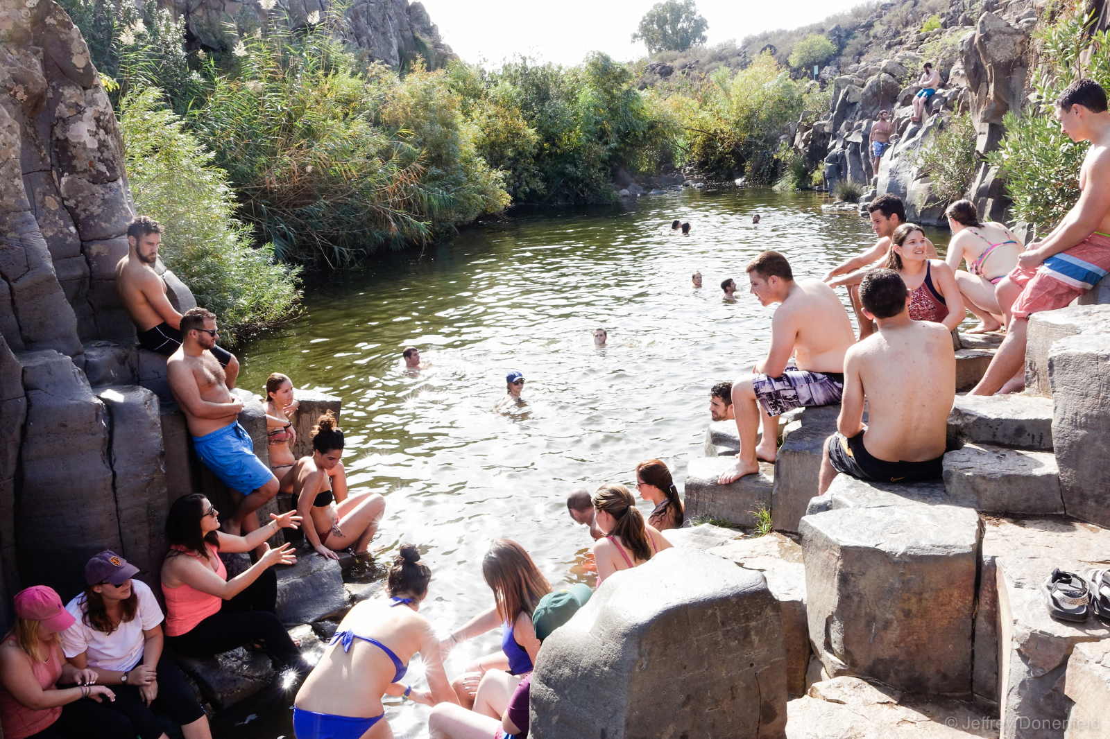 Cooling off in one of the swimming holes along the Yehudiya Canyon Trail, Golan Heights, Israel. This is one of many beautiful swimming holes in the area, flanked by hexagon-shaped basalt columns.