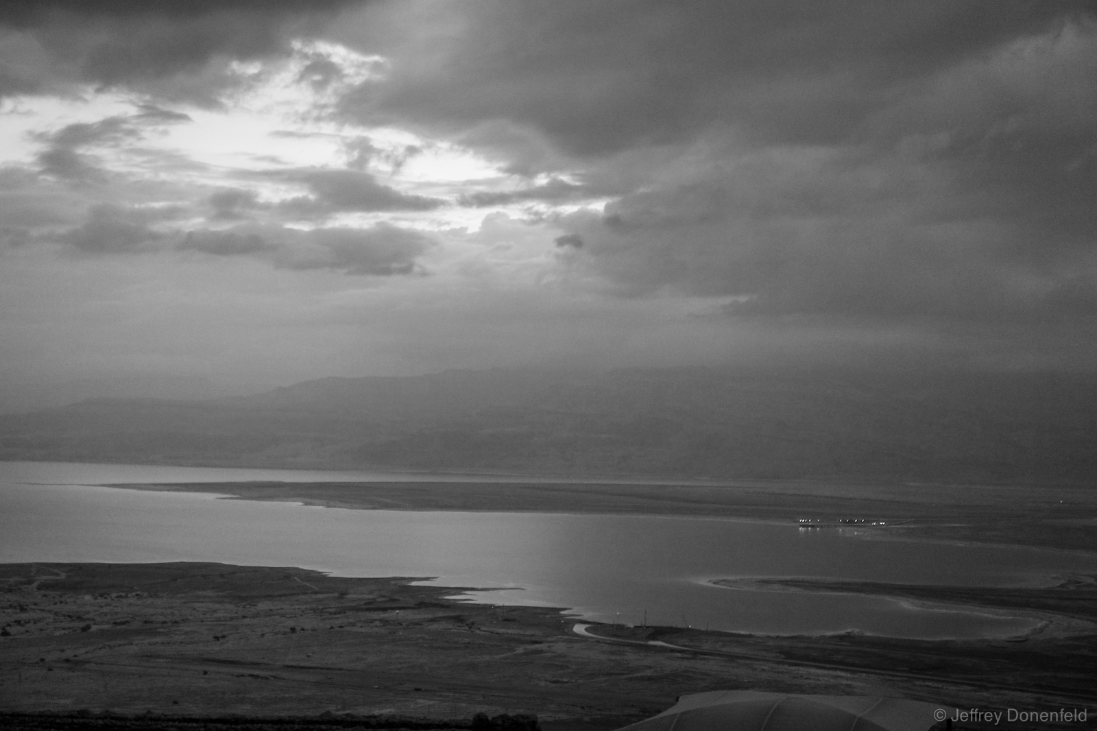Sunrise burns through early morning clouds over the Dead Sea, as seen from Mt. Massada.
