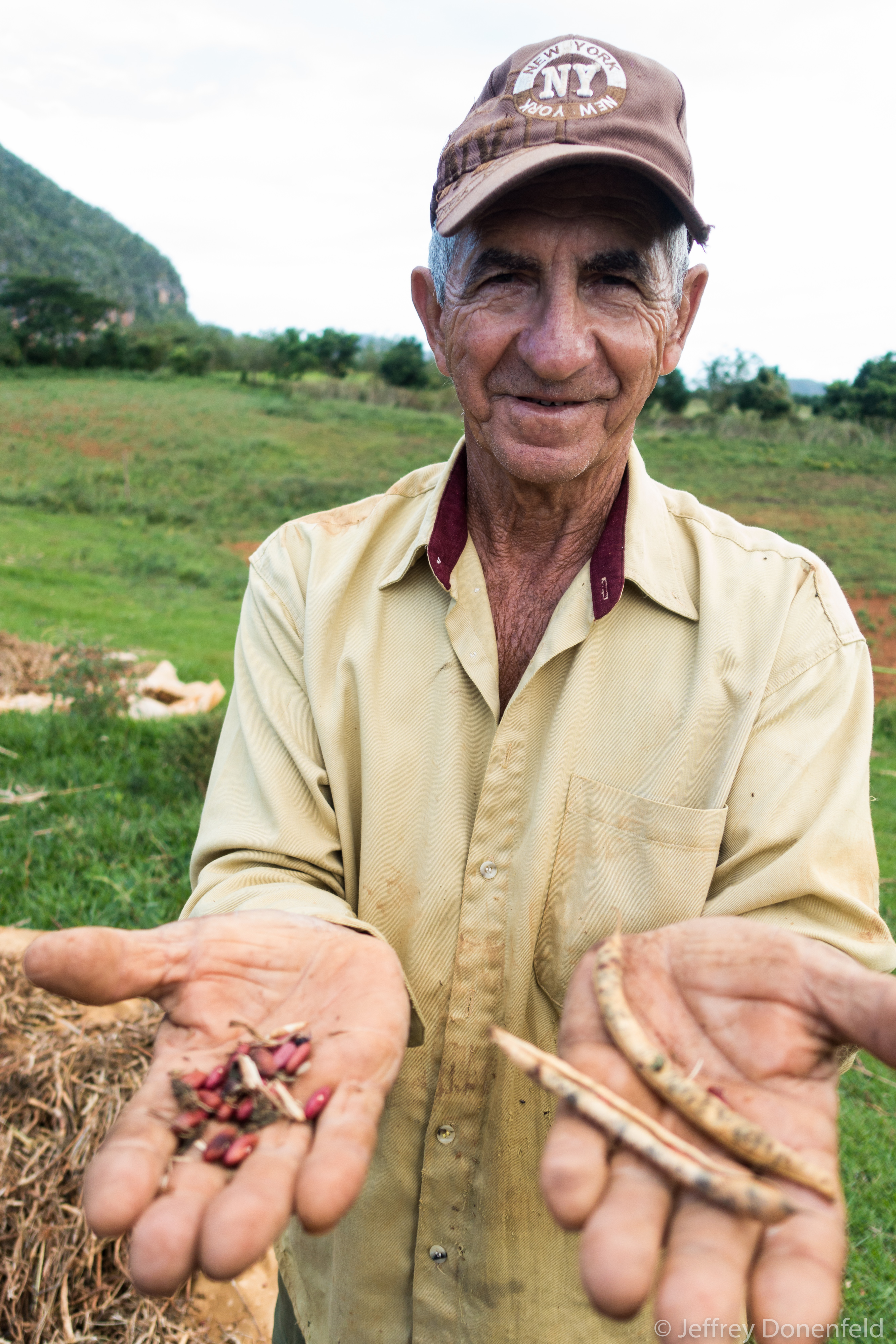A local farmer shows us the red beans he grows on his farm. Jeffrey